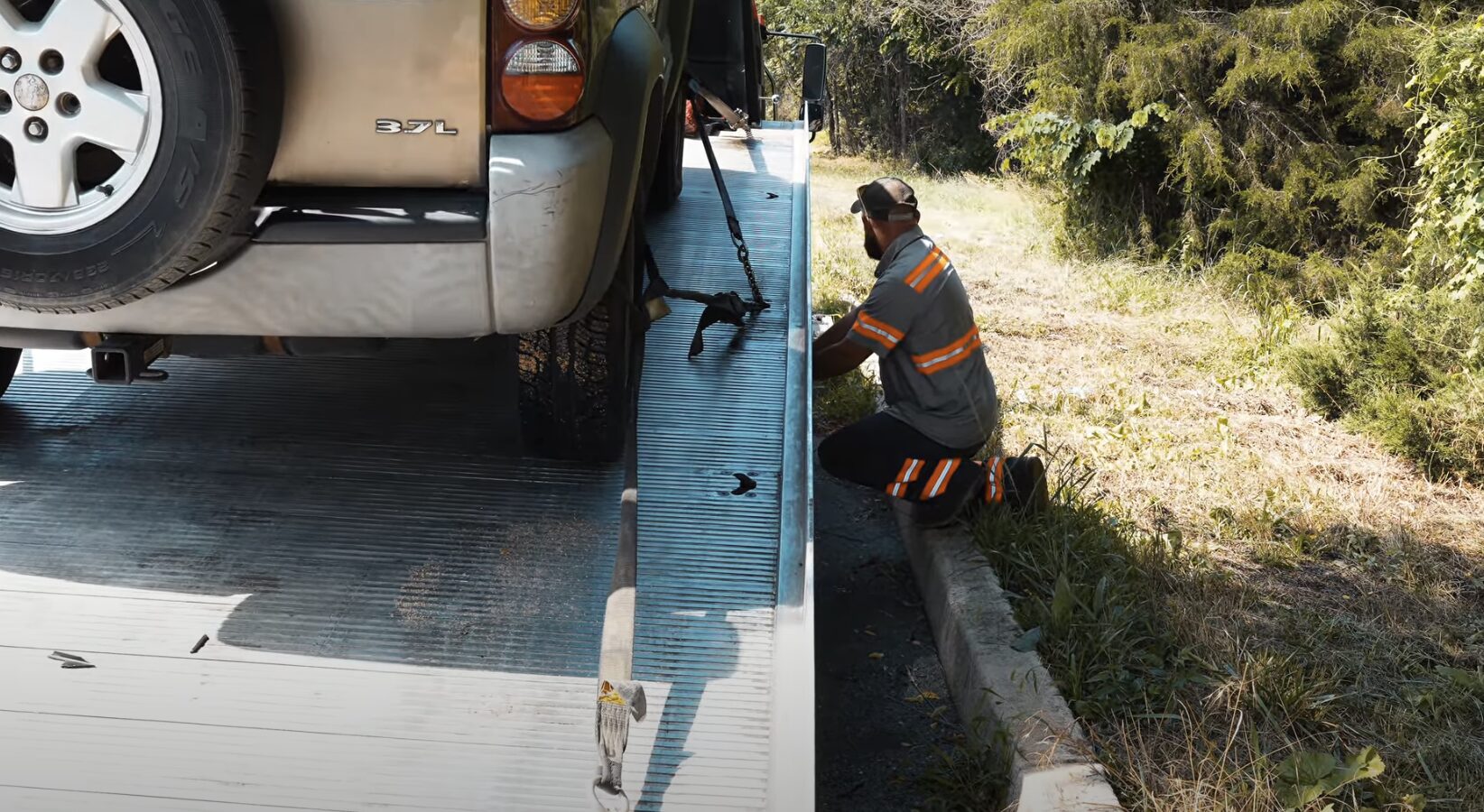 Expert towing services in Pharr, TX Professional tow truck operator securing vehicle on flatbed